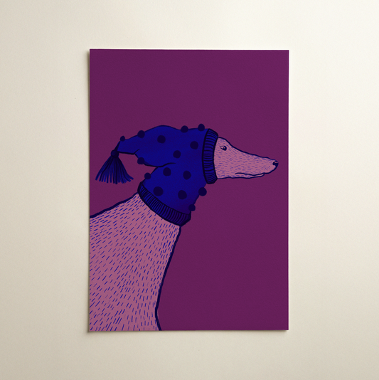 greyhound dog wearing a cute winter hat